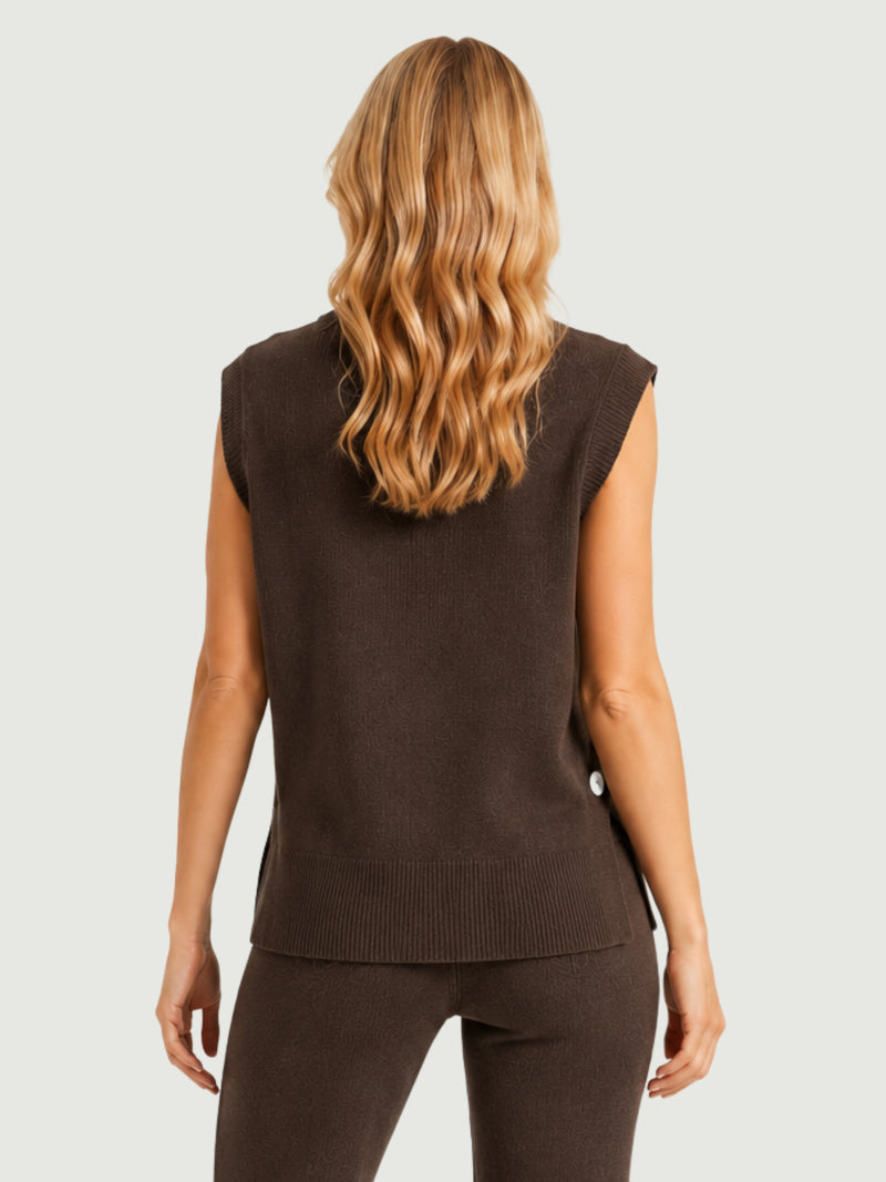 Vista posteriore modella indossa gilet smanicato marrone con aperture laterali chiuse da bottoni in madreperla