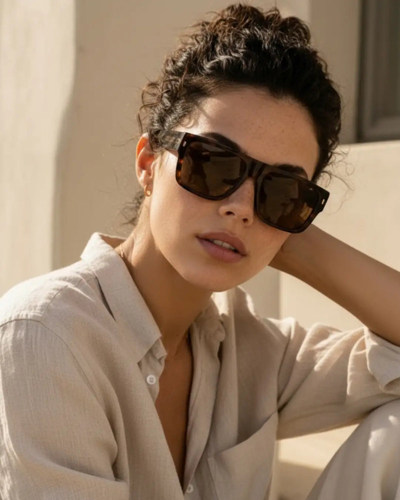 modella indossa occhiale da sole montatura in acetato tartarugato lucido, lenti marroni