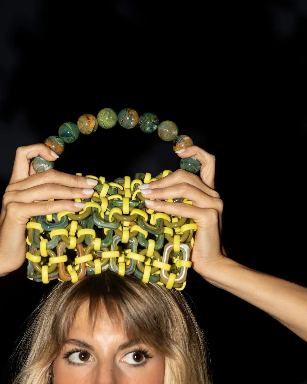 modella indossa borsa a mano in resina multicolore lime, verde e arancione 